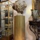 Large fluted golden wood column with a marble top, work from around 1900.