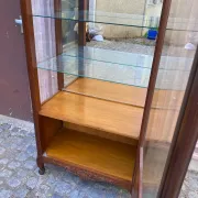 Louis XV style display cabinet in cherry wood with a mirrored back and glass shelves.