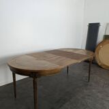 Louis XVI style dining table with a leather top.