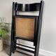 Vintage folding chairs in black wood and cane.