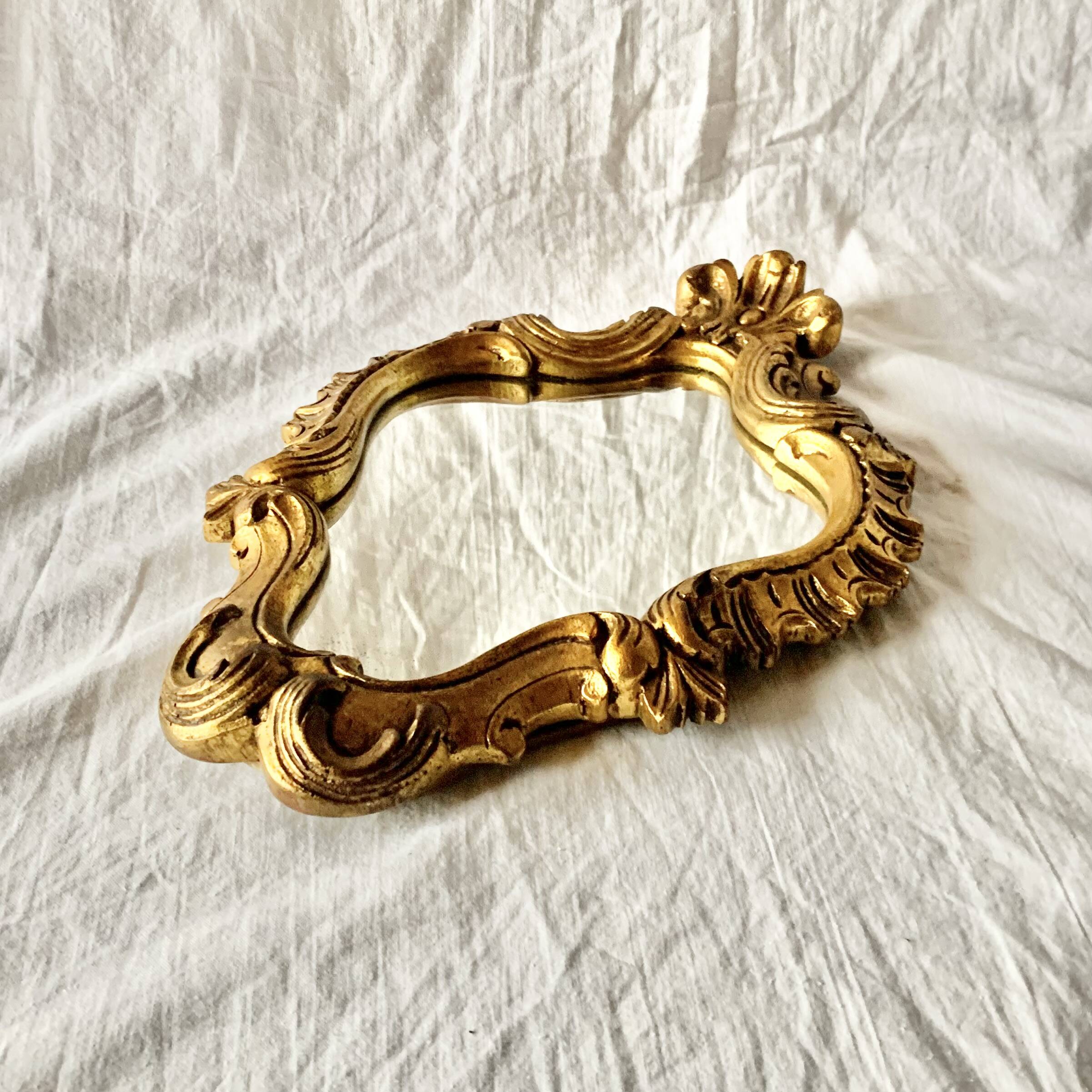 Rococo wall mirror in golden resin