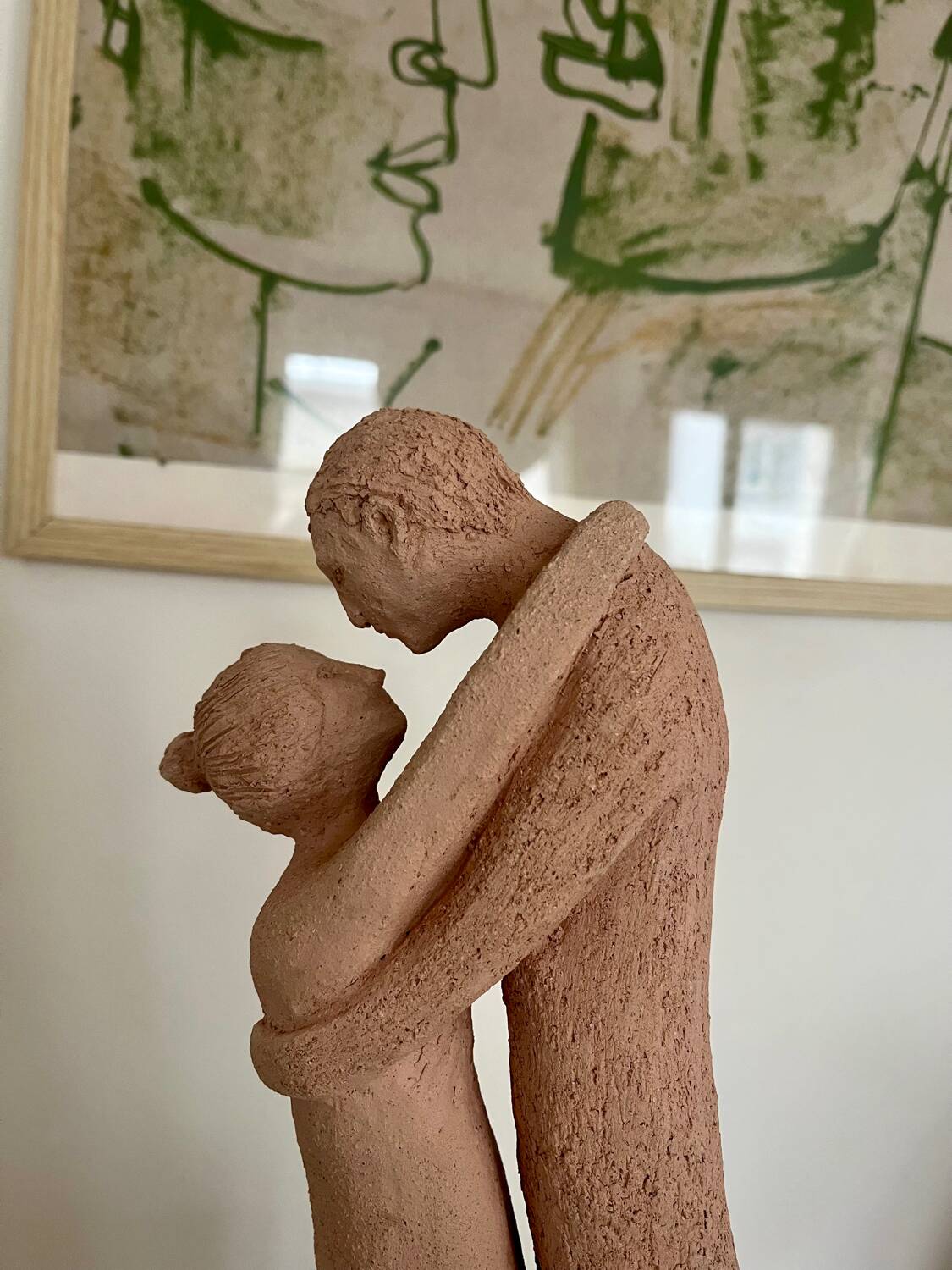 Sculpture of a couple entwined in grog clay.