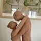 Sculpture of a couple entwined in grog clay.