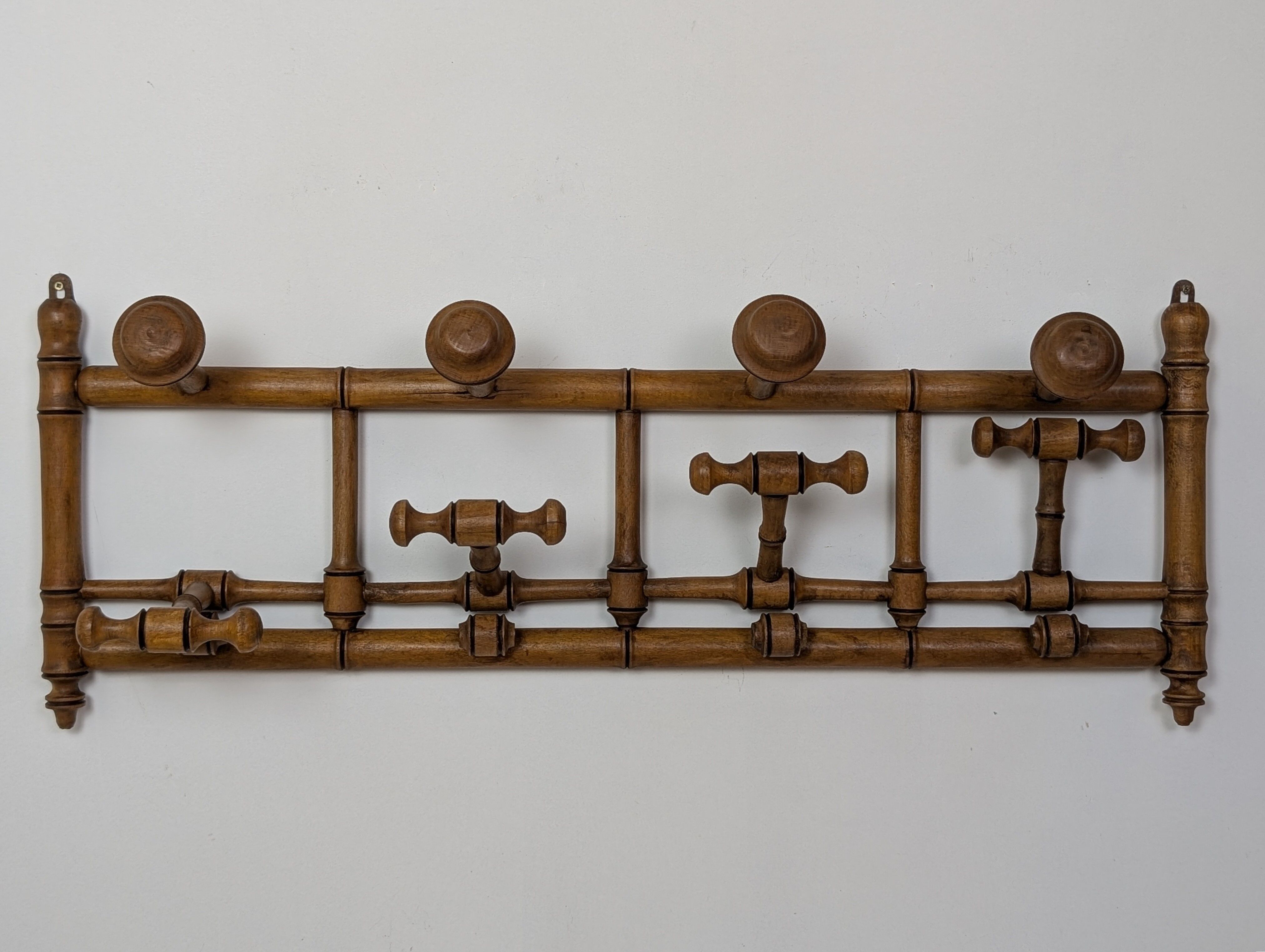 Wall-mounted coat rack made of turned wood