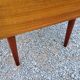 60s desk in golden blond mahogany with conical coffered feet