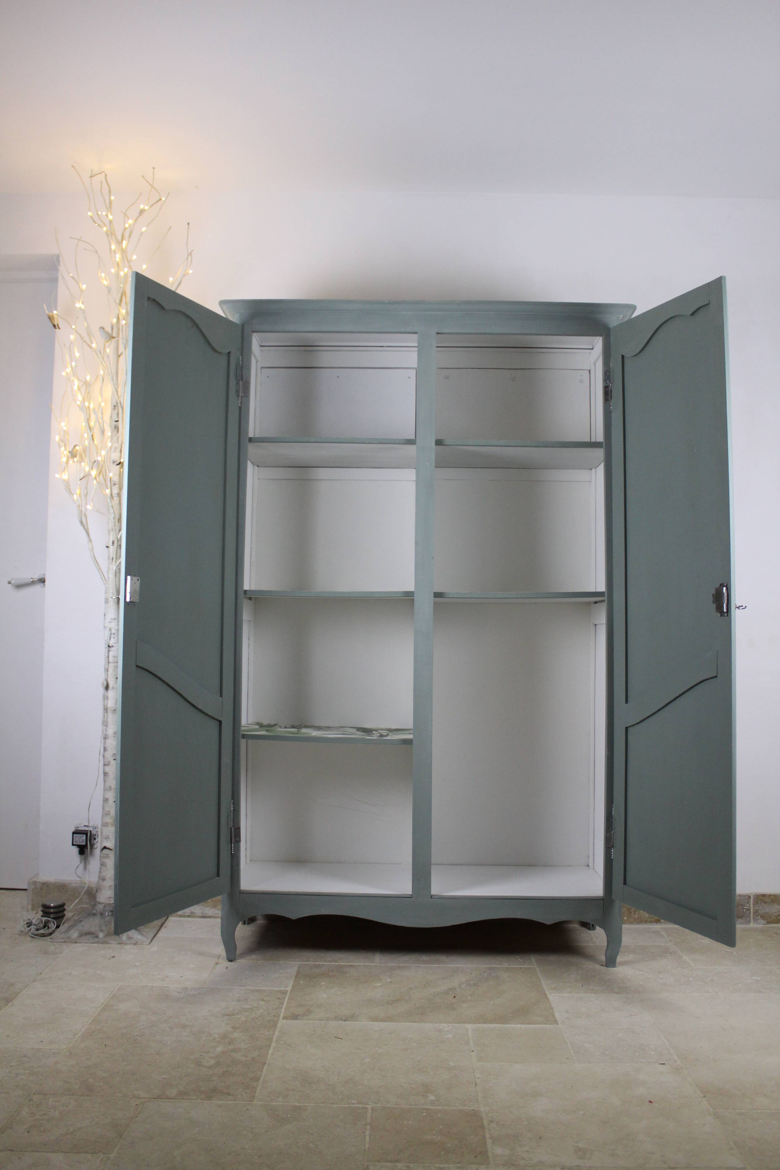 Renovated Parisian wardrobe – sage green with white patina