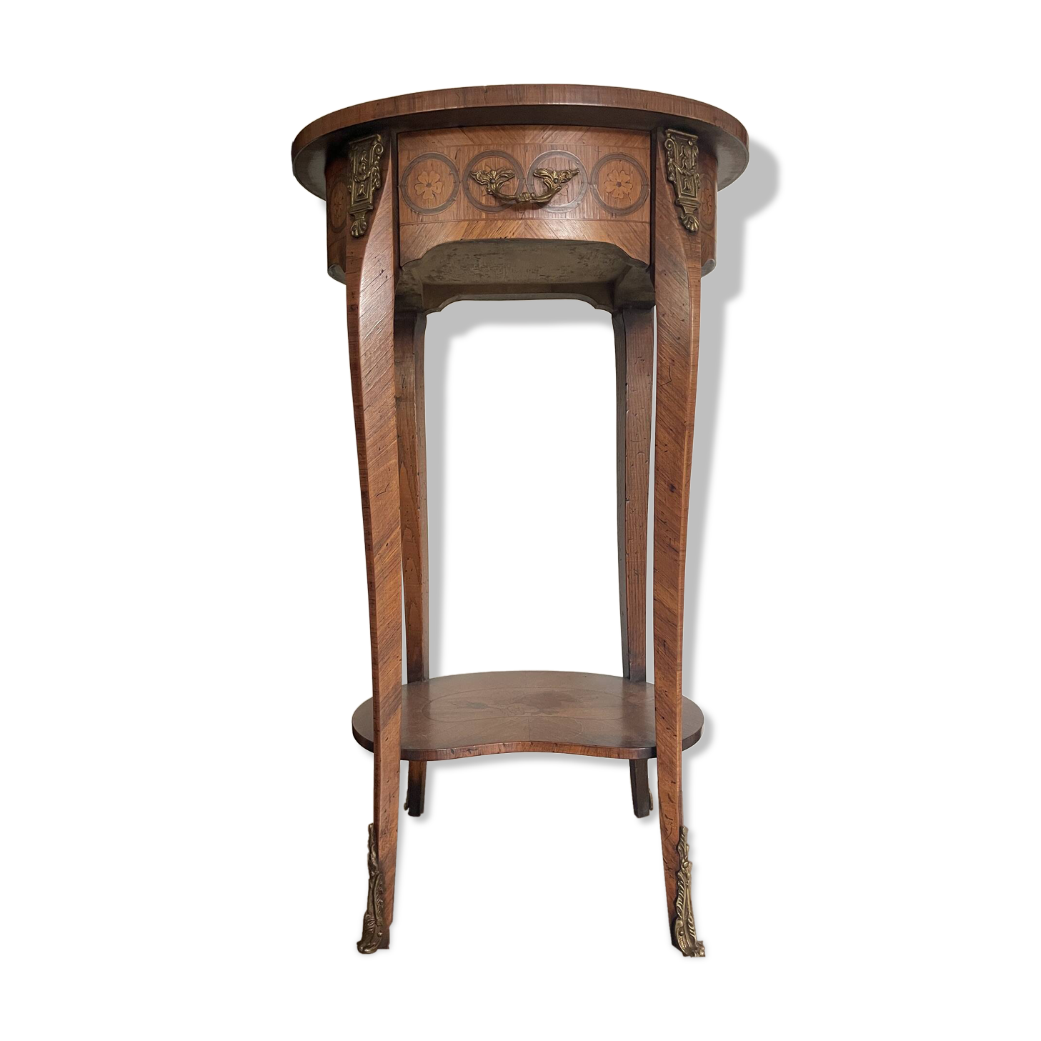 Oval bedside table from the Transition period in marquetry and bronze.