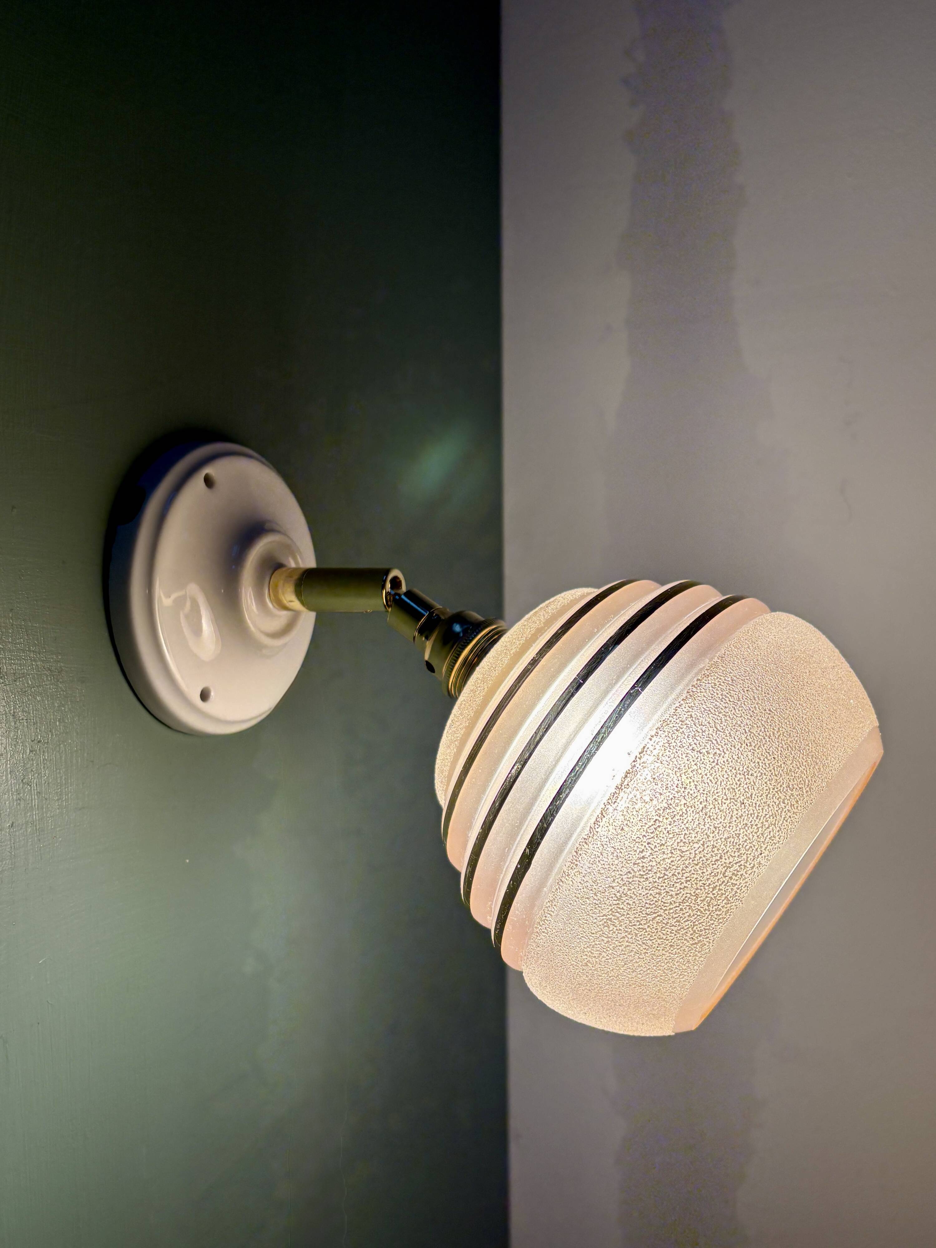 Vintage globe wall light in frosted pink and gold glass.