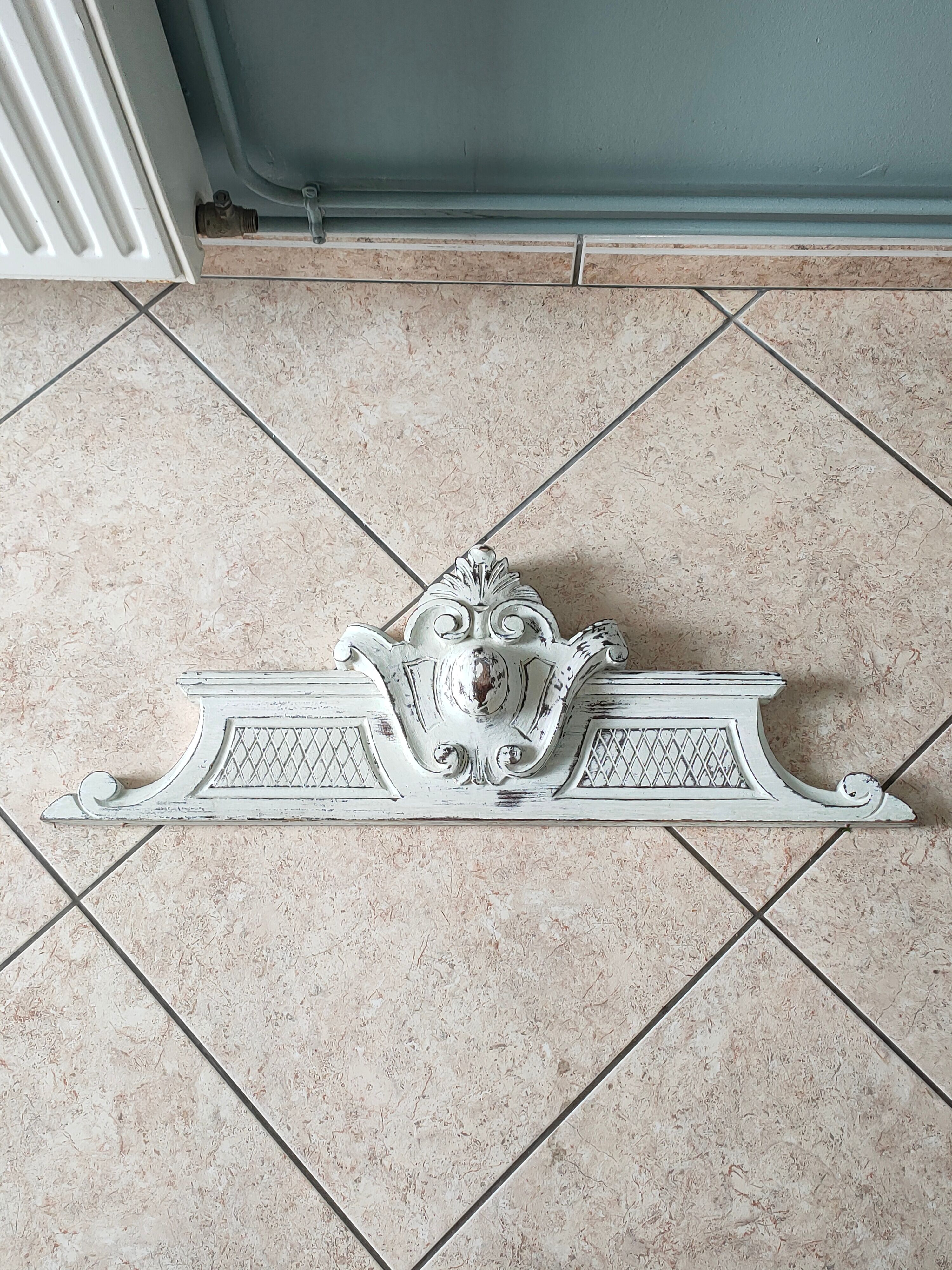 Old pediment in painted wood