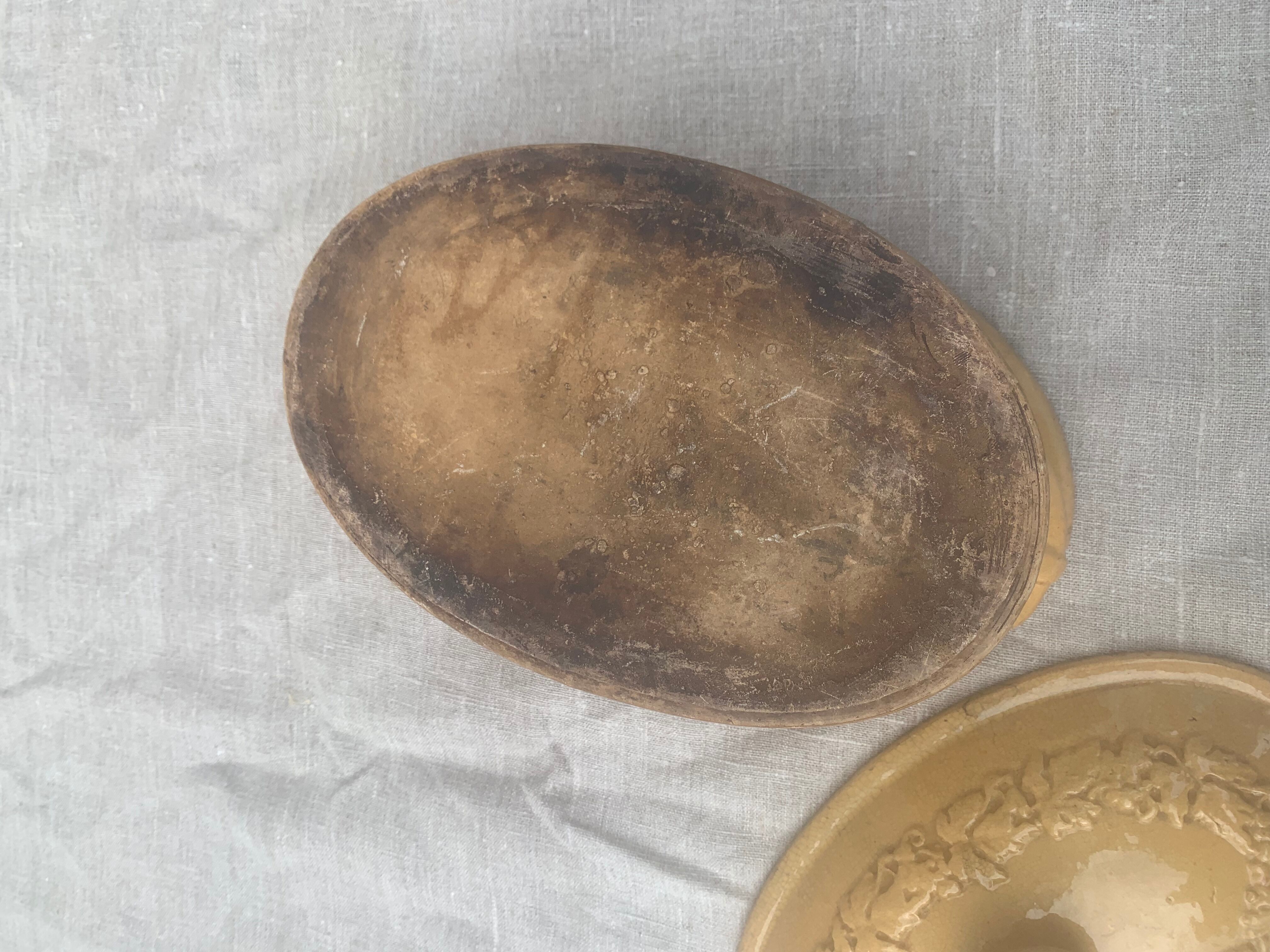Old terrine in glazed stoneware and floral decoration mustard yellow slip