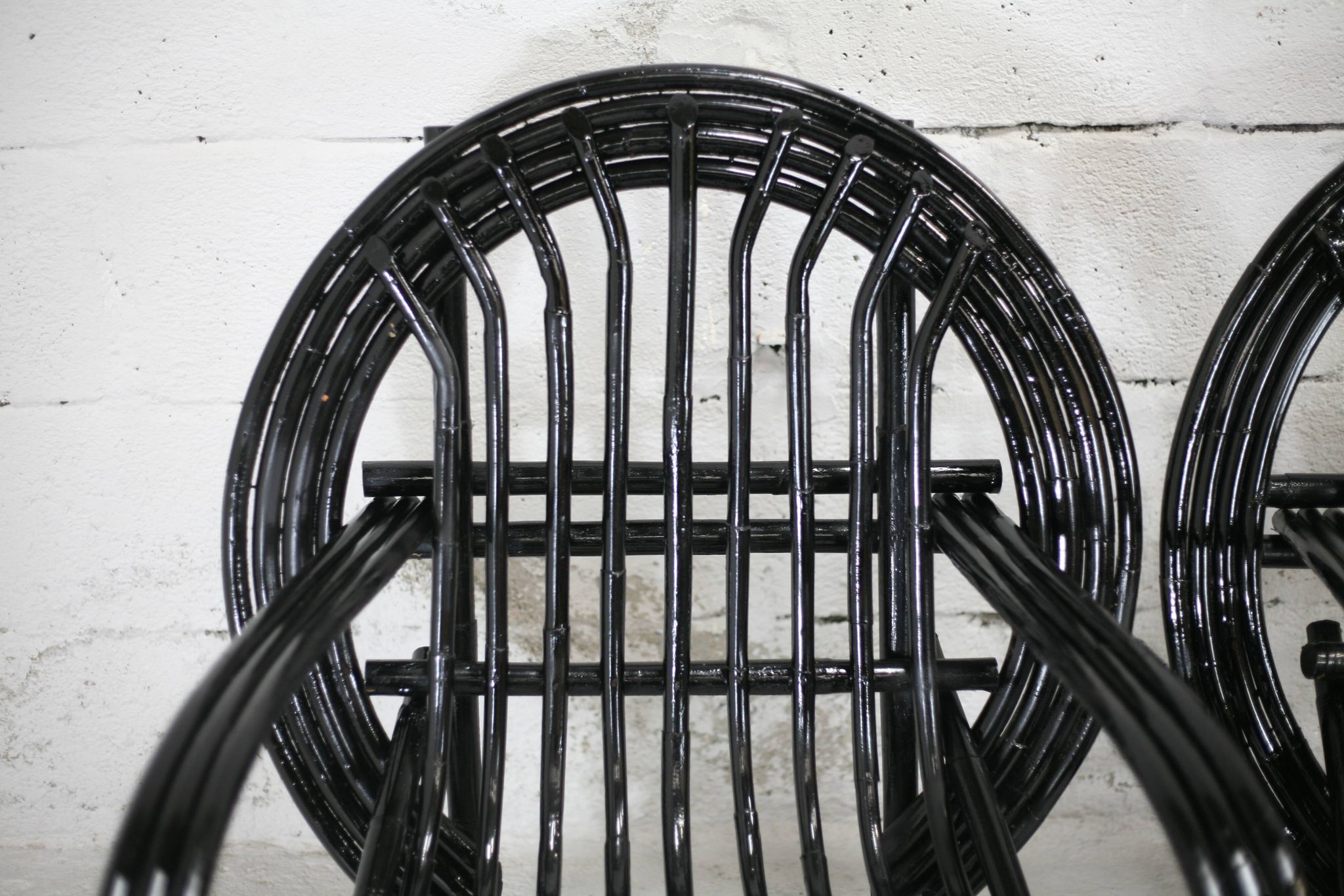 Pair of black lacquered rattan armchairs. France, cira 1960.