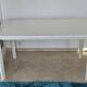 Glossy white table for dining room with white metal legs, in very good condition.