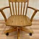 Solid wood swivel and reclining armchair.