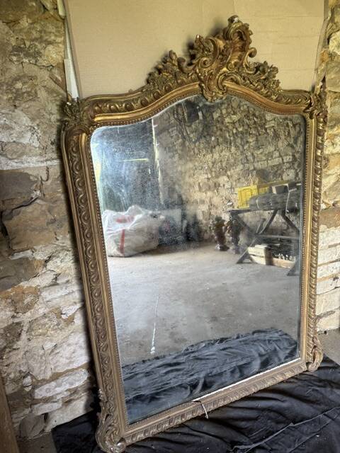 Large antique mirror in wood and gilded stucco.