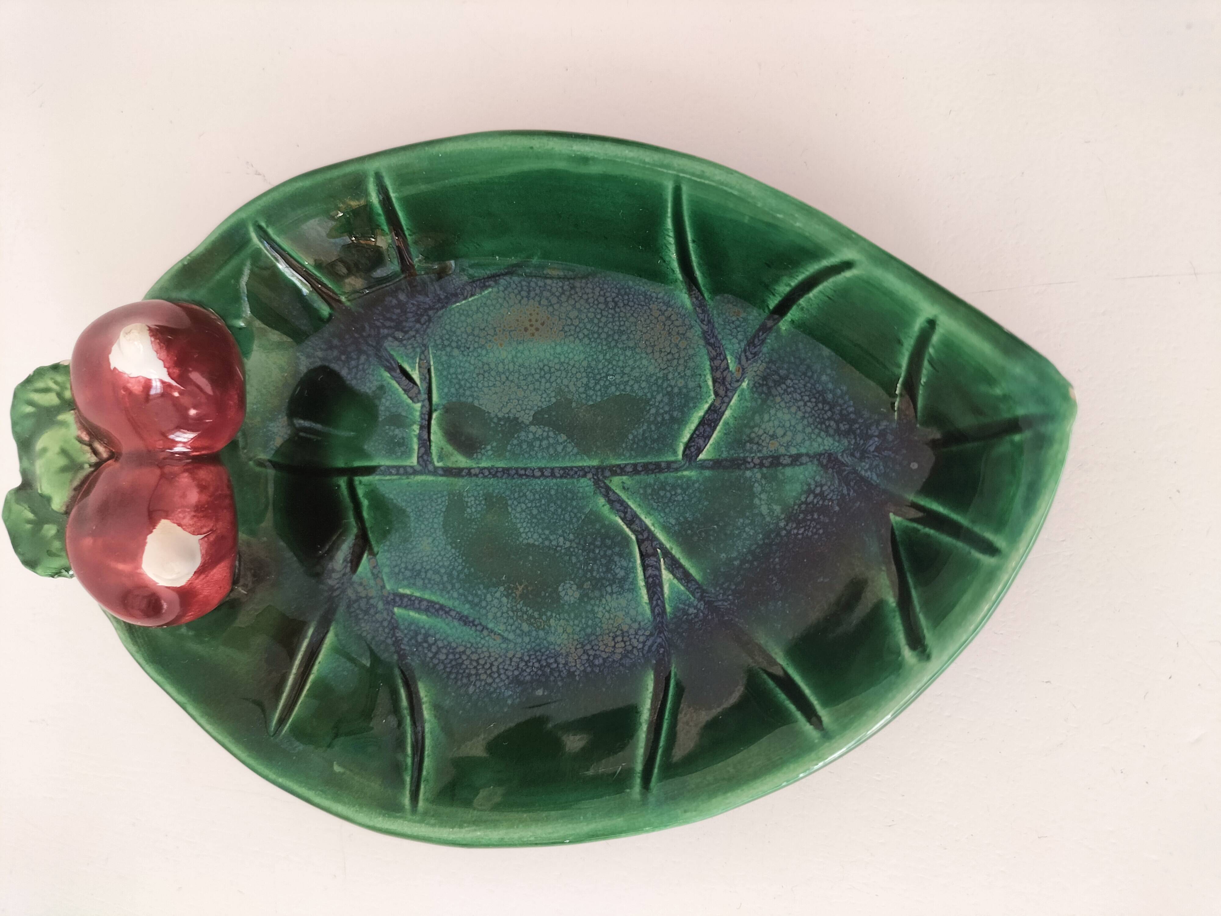Two relief bowls with leaf designs, radishes, and tomatoes.