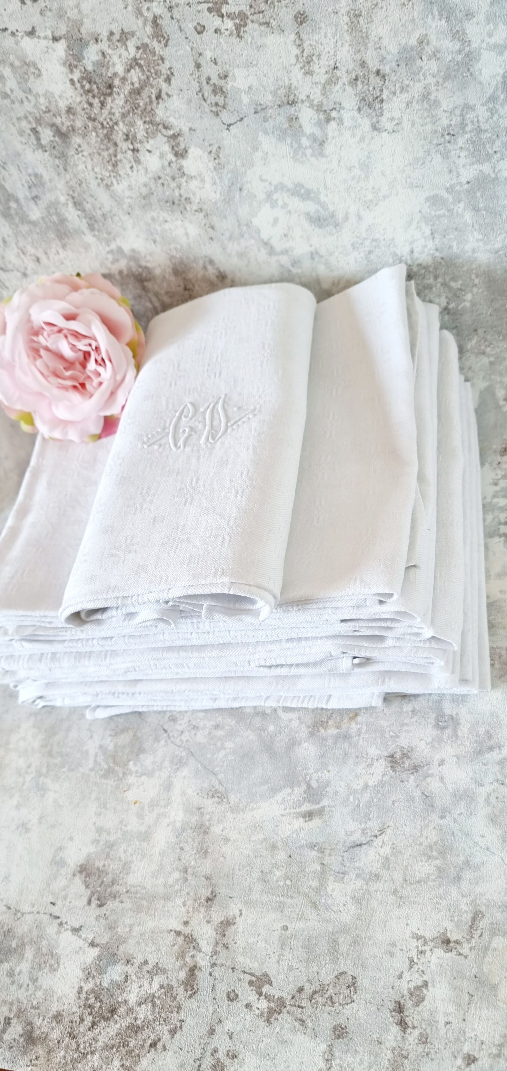 12 antique French linen towels with damask embroidery with "GB" anagrams.