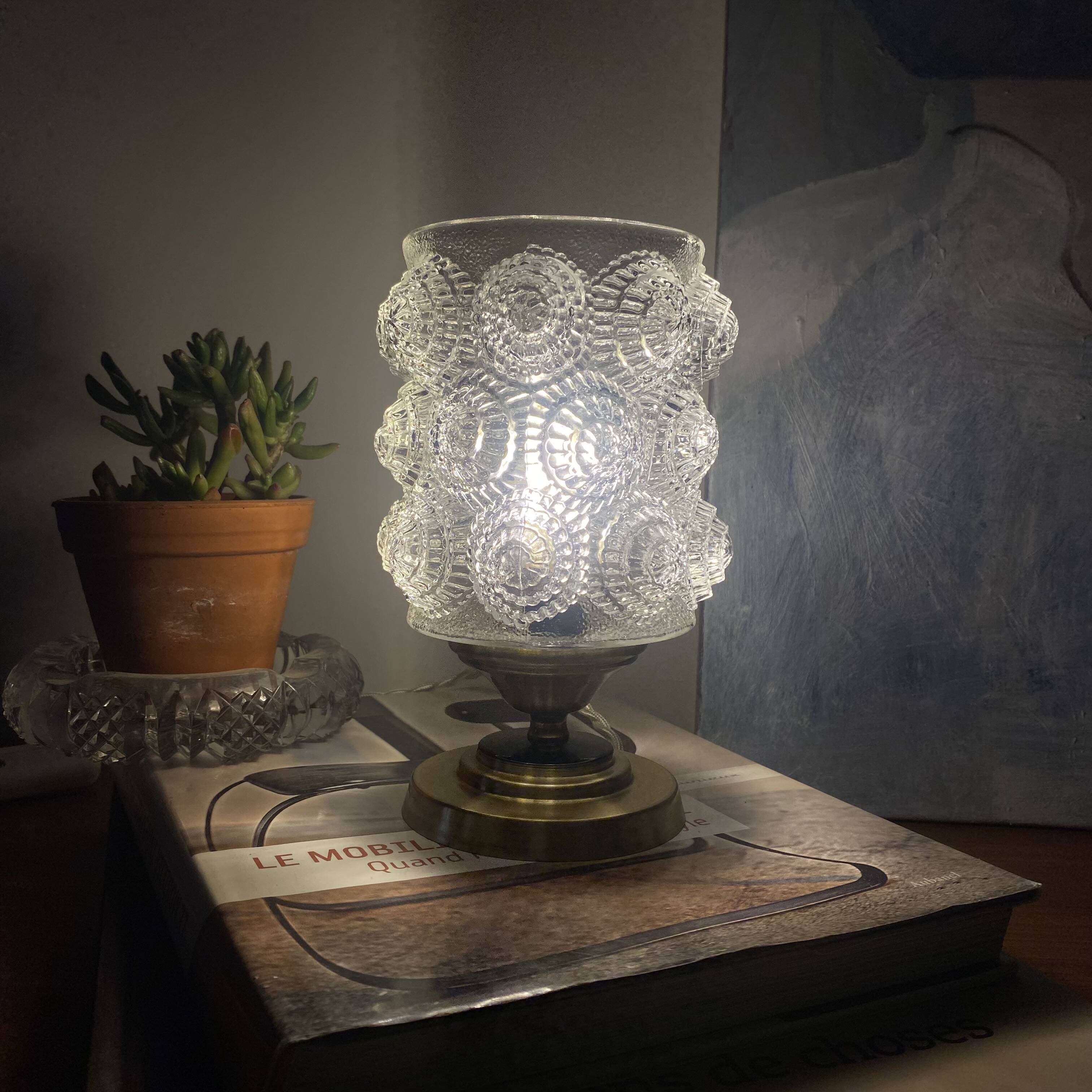 Antique globe table lamp in moulded transparent glass with a brass base.