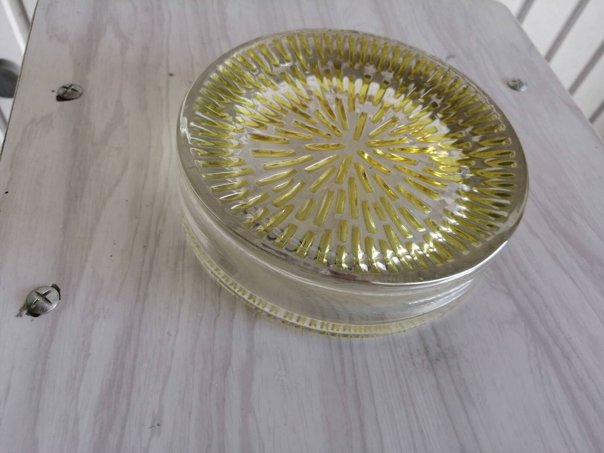 Empty round pockets of iridescent transparent glass of yellow sticks