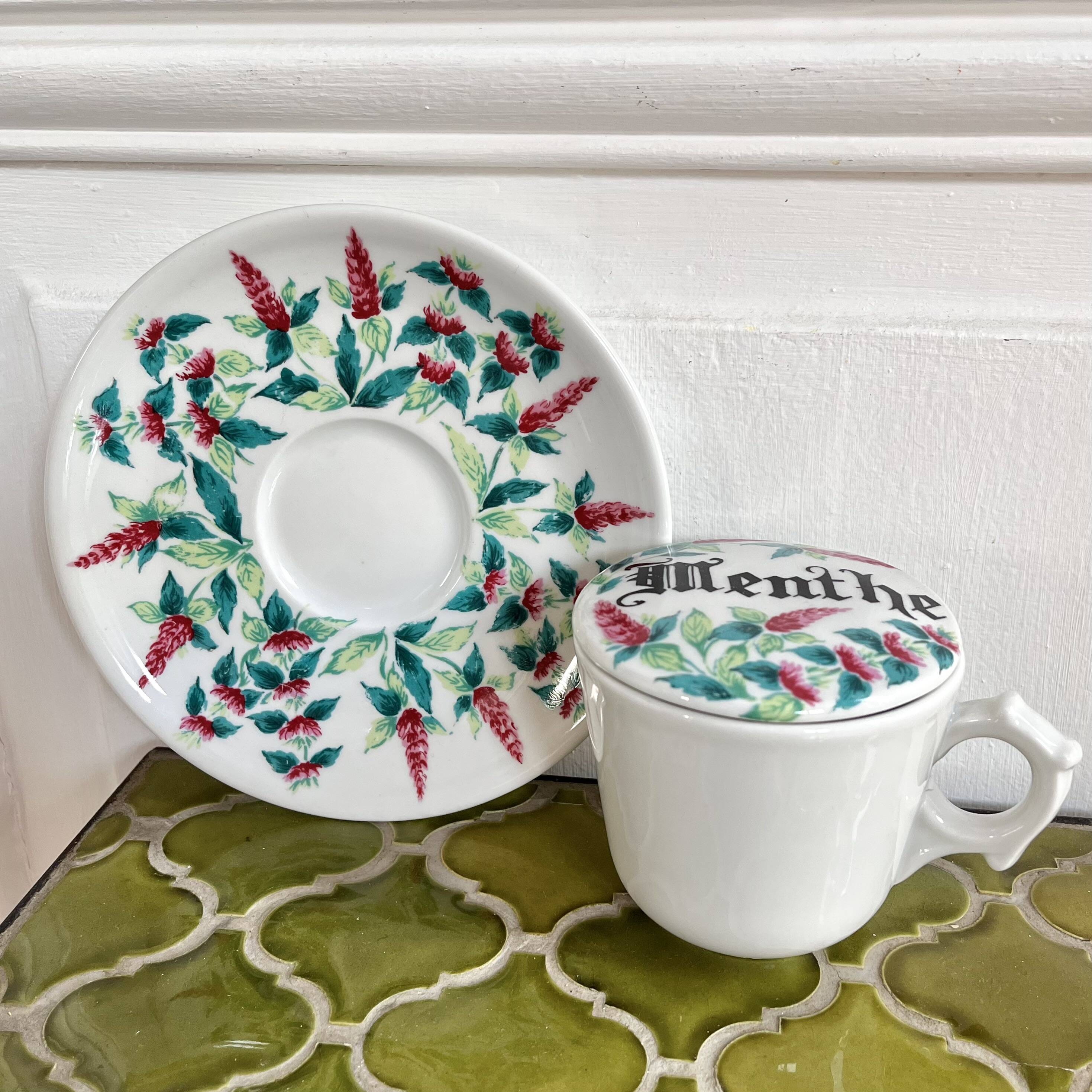 Antique herbal tea cup with mint infusion