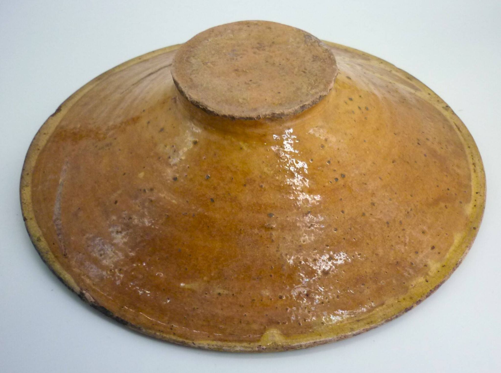 Old omelette turner, glazed yellow terracotta, south of France.