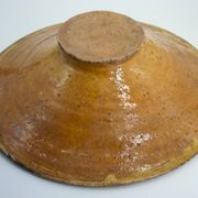 Old omelette turner, glazed yellow terracotta, south of France.