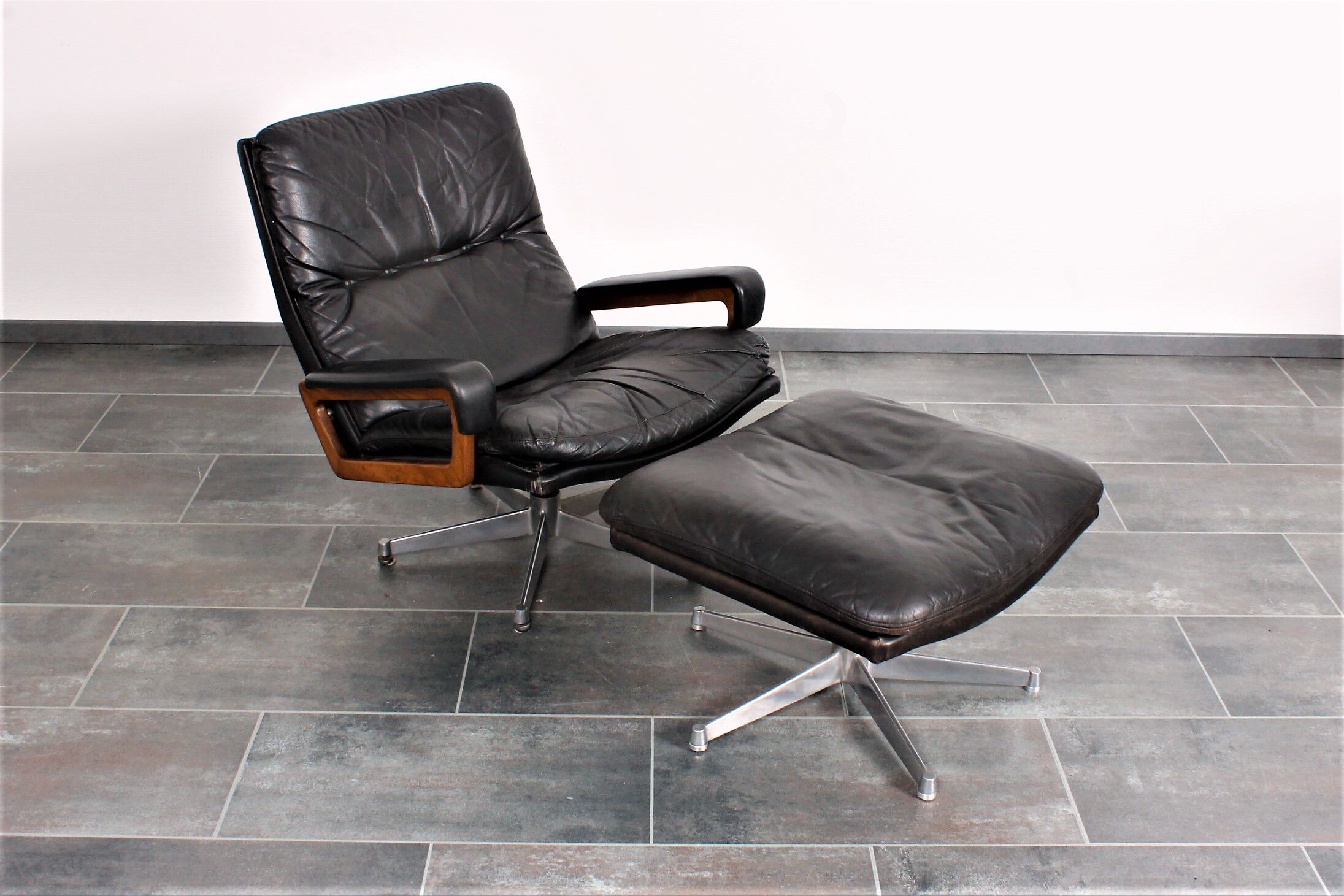Armchair and footstool by André Vandenbeuck for Strässle in black leather