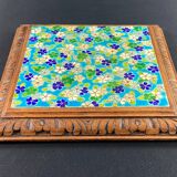 Longwy earthenware trivet on wooden mount, early 20th century