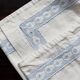 Vintage embroidered pillowcase with light blue thread.