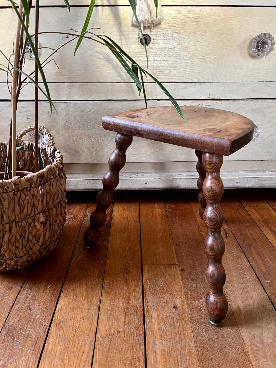 Low vintage wooden tripod stool