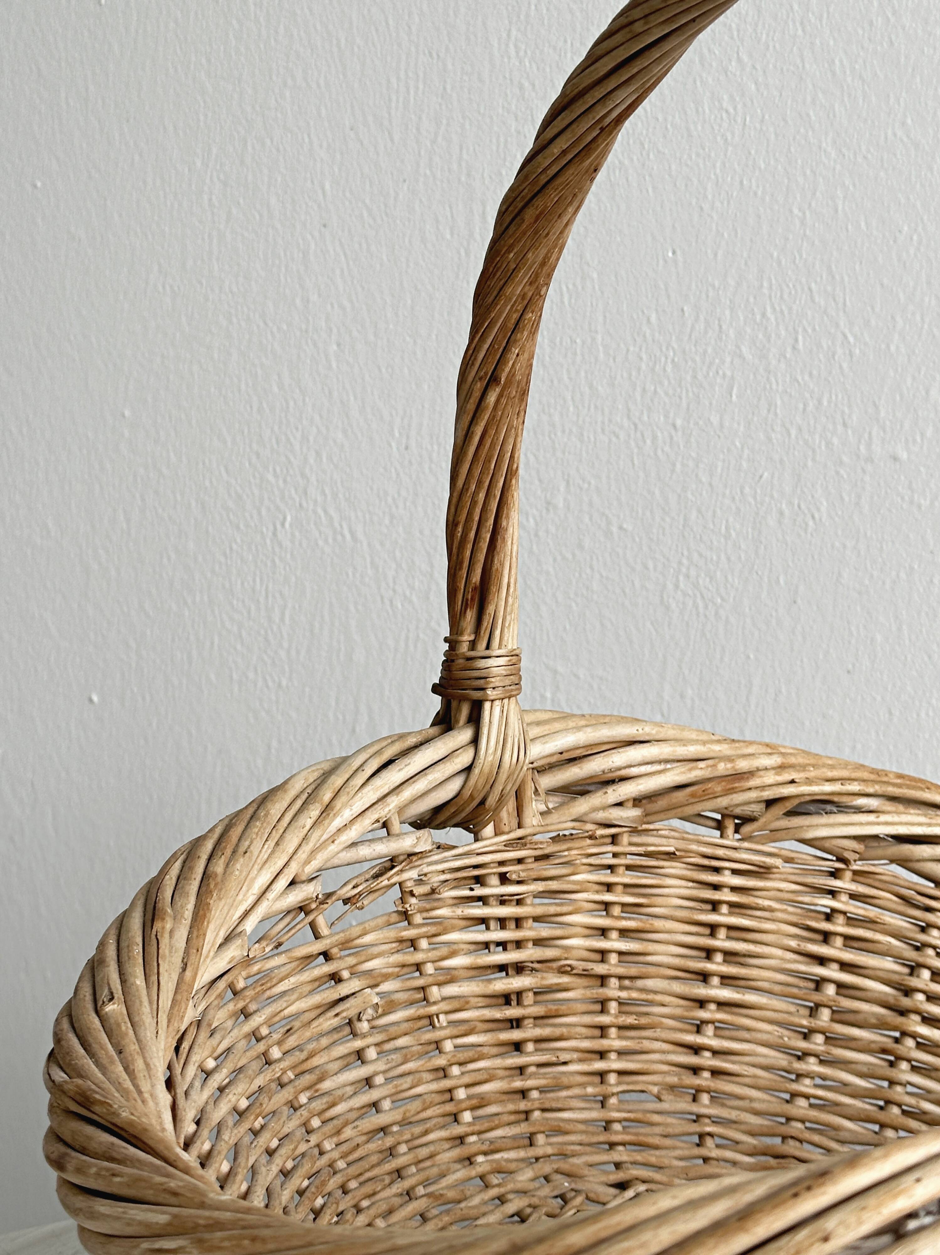Large antique woven wicker basket with handle.