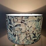 Table lamp with chrome stem, tropical plant shade.