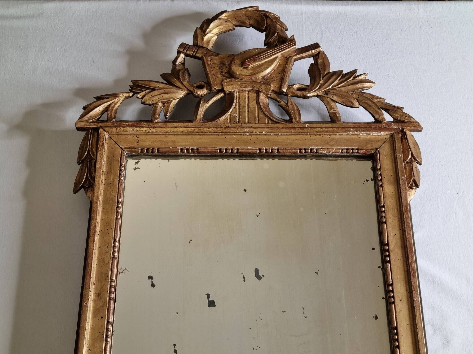Antique carved and gilded wooden mirror, Louis XVI style – 54 x 92 cm