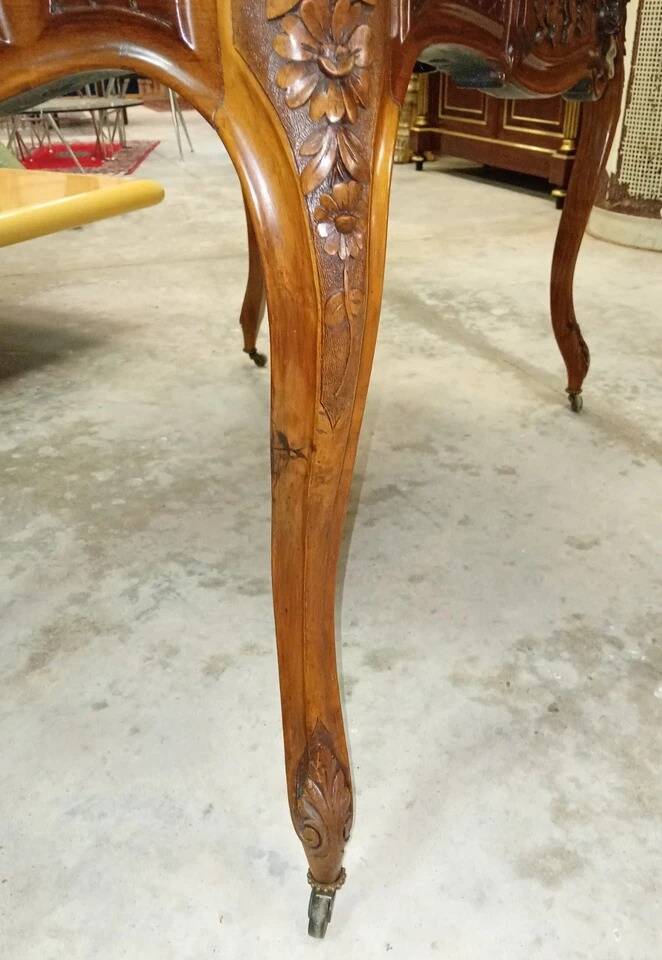 Curved desk in Louis XV style, made of carved and moulded walnut.