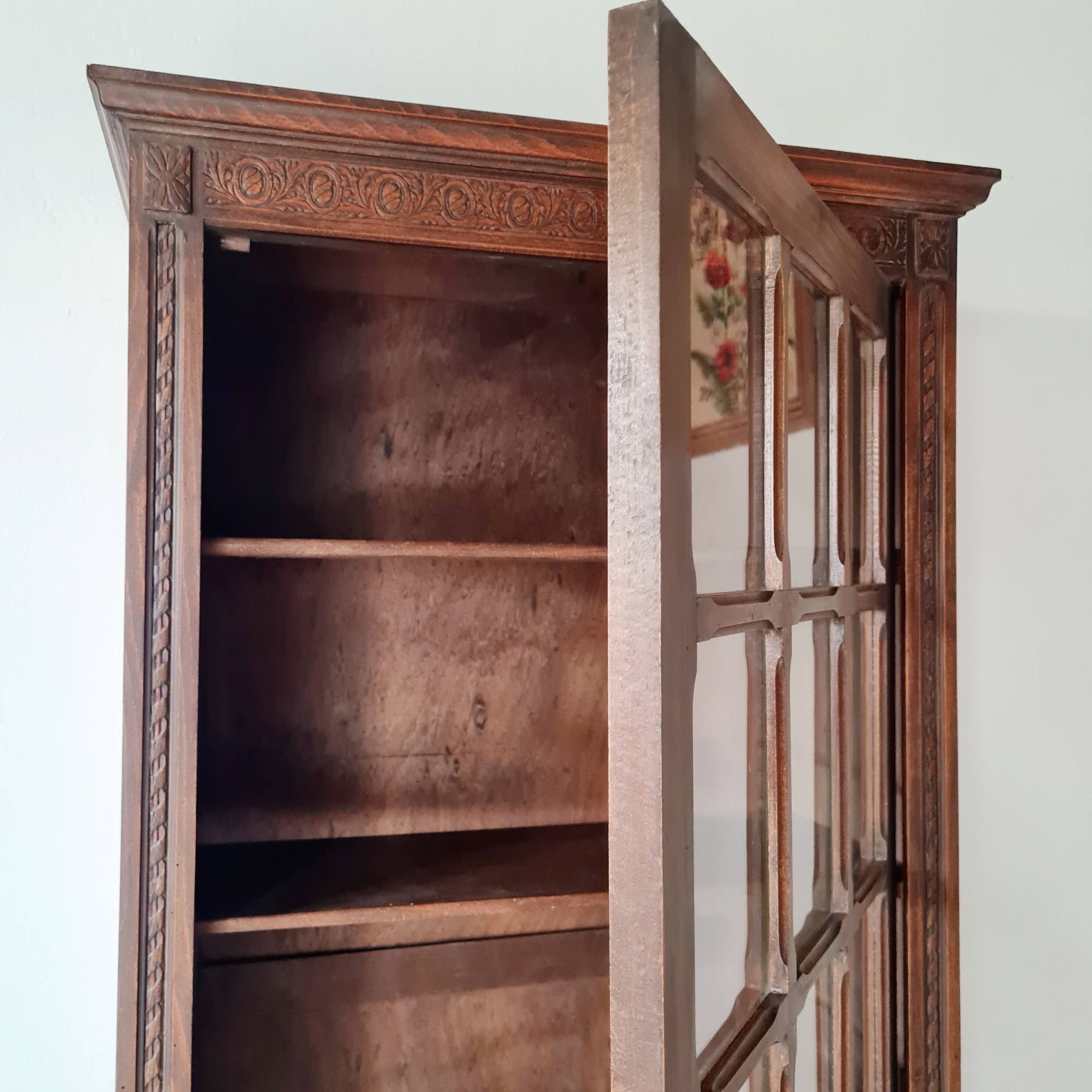 Old glass-fronted library in solid wood