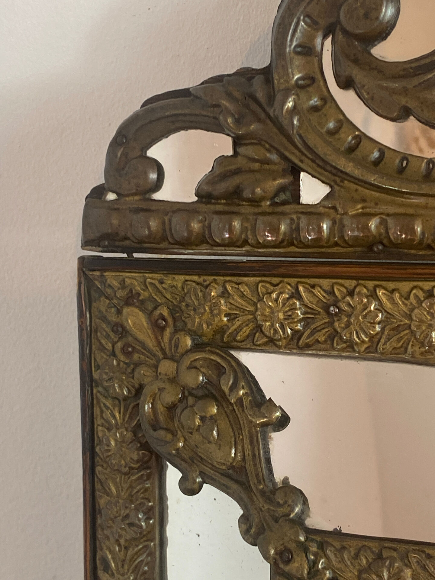 Mirror with brass repoussé frame