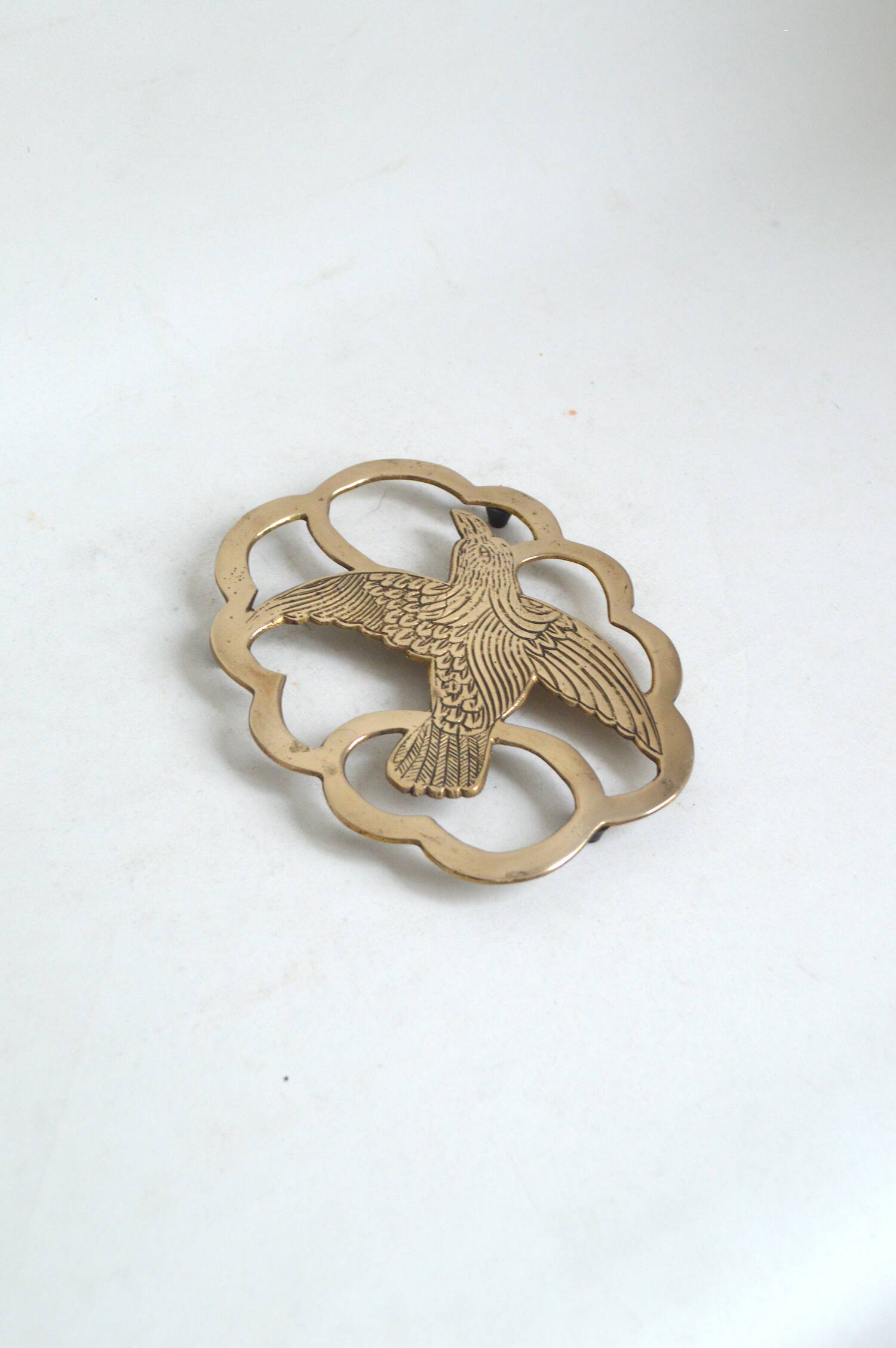 Brass bird trivet