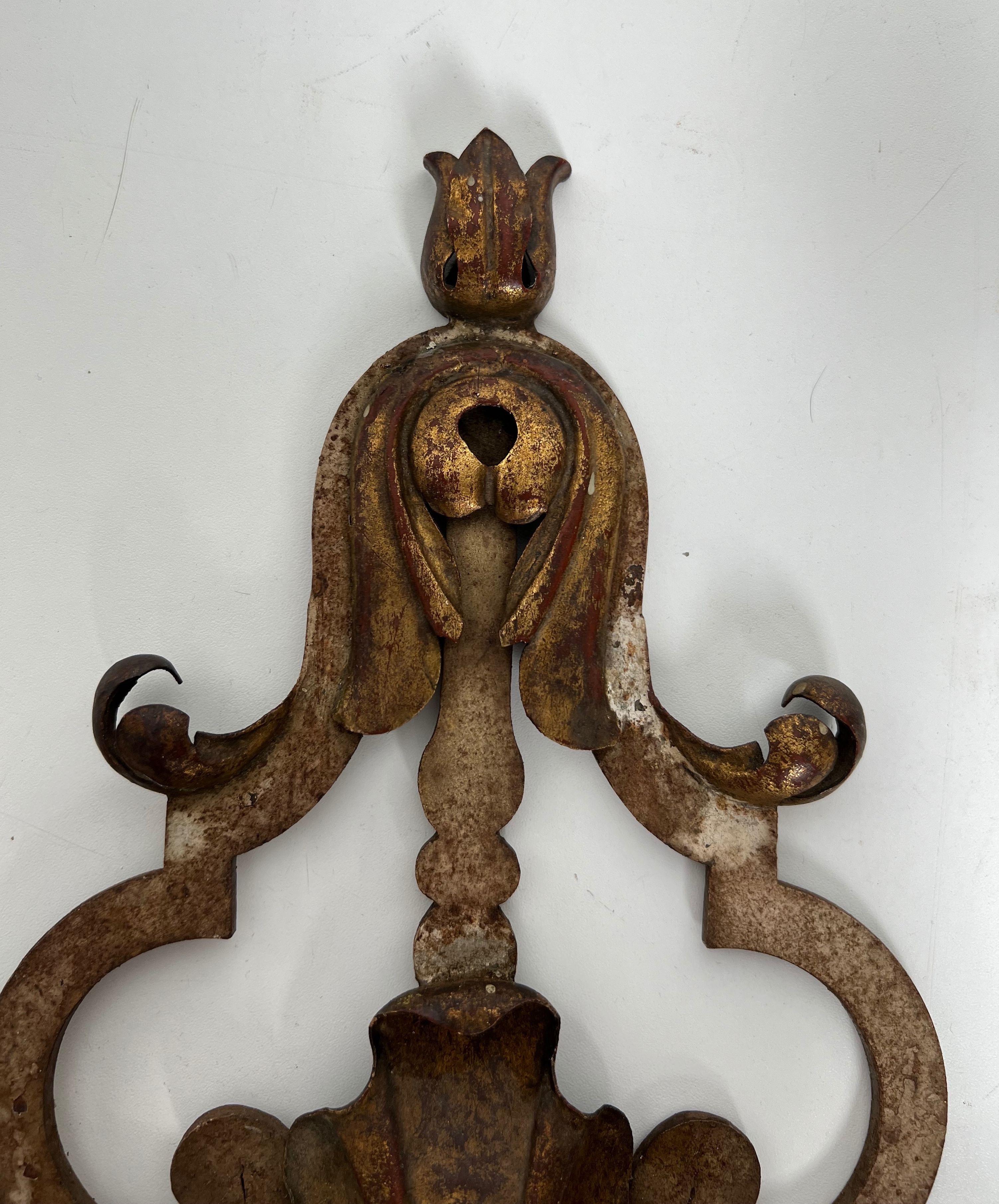 Pair of patinated wrought iron wall sconces with golden acanthus leaves and crystals.