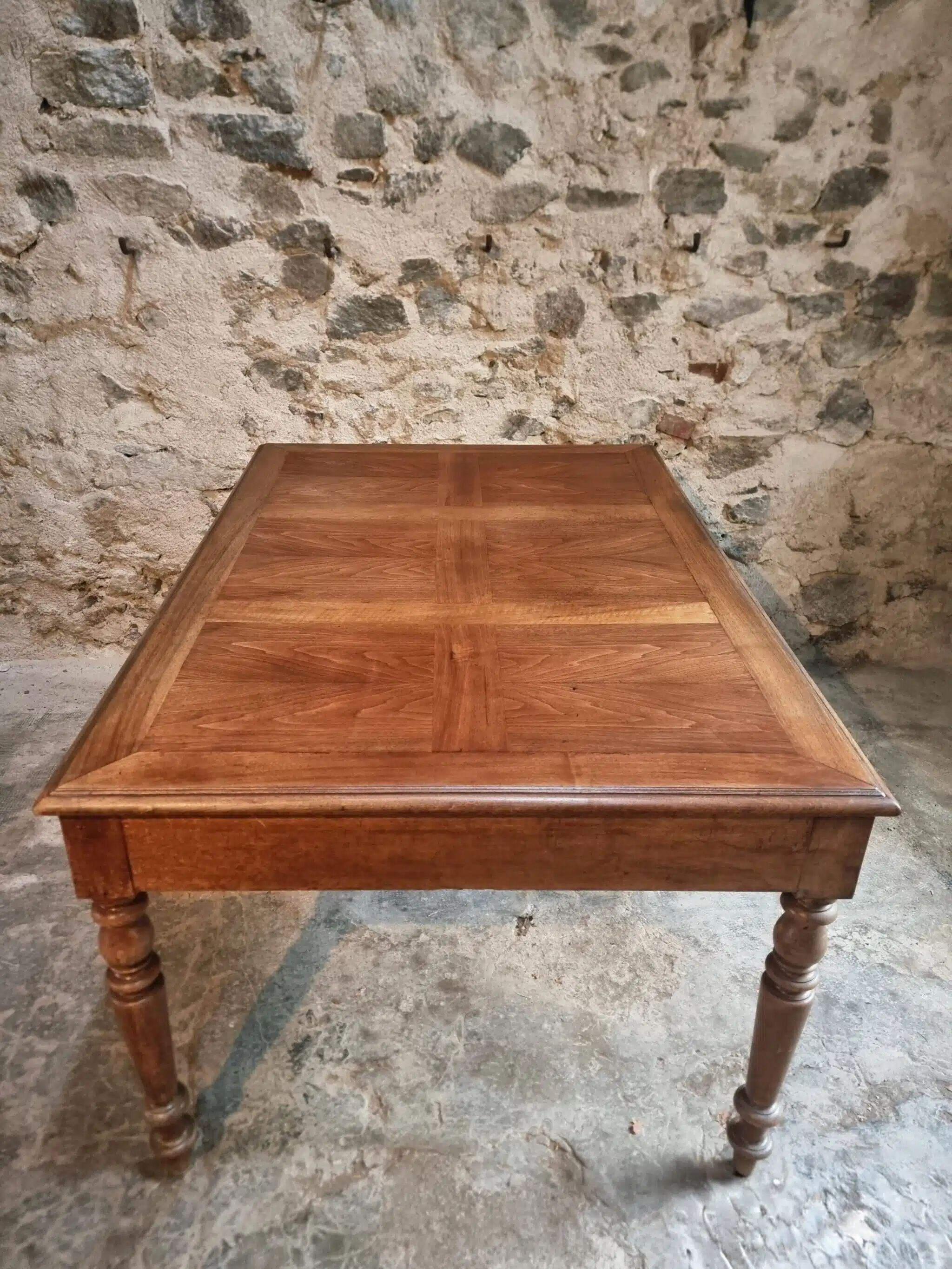 Antique French walnut table with six drawers, parquet top, early 20th century.
