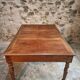 Antique French walnut table with six drawers, parquet top, early 20th century.