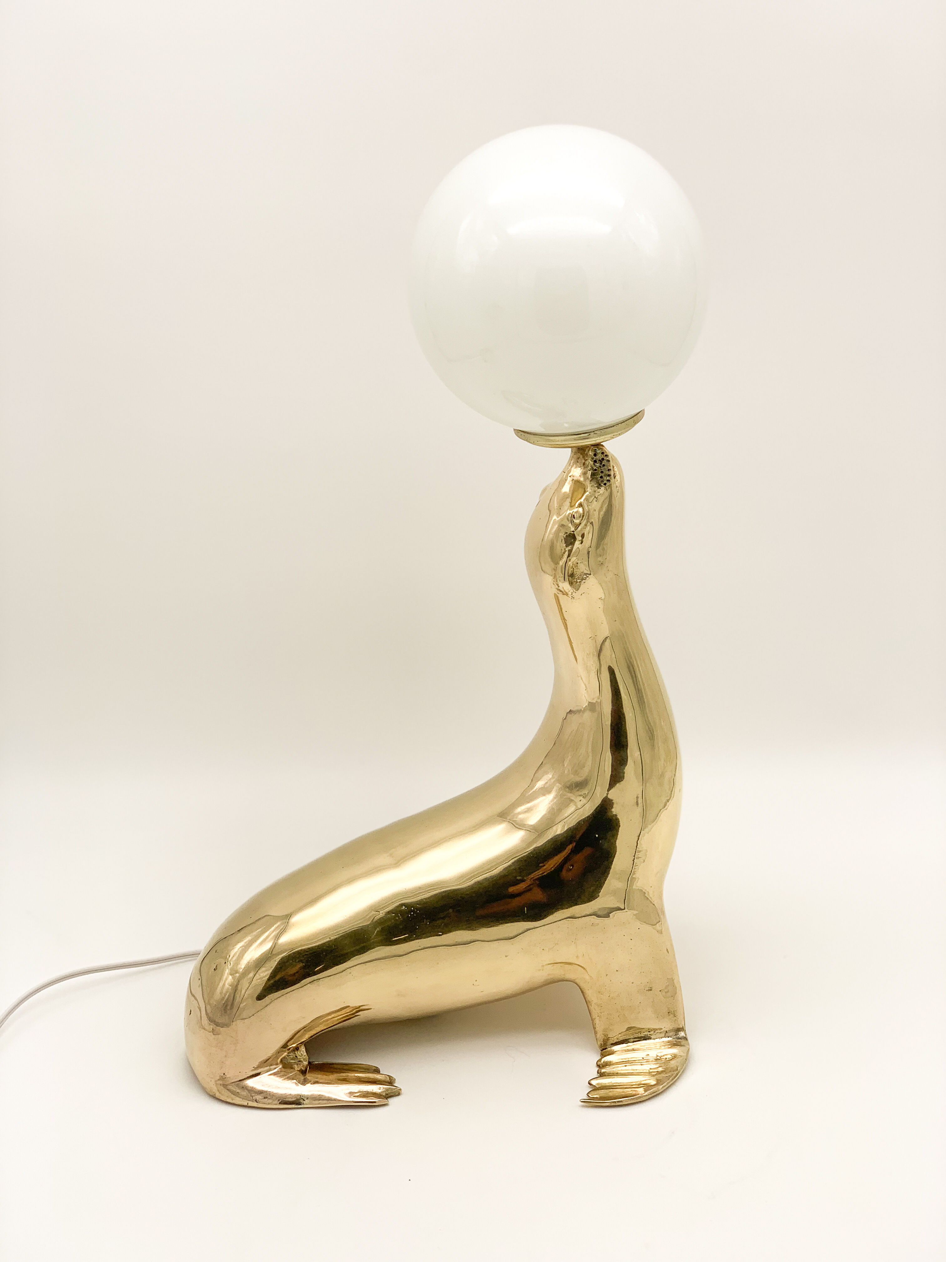 Vintage brass sea lion lamp