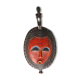 African wooden mask, face topped with a bird.