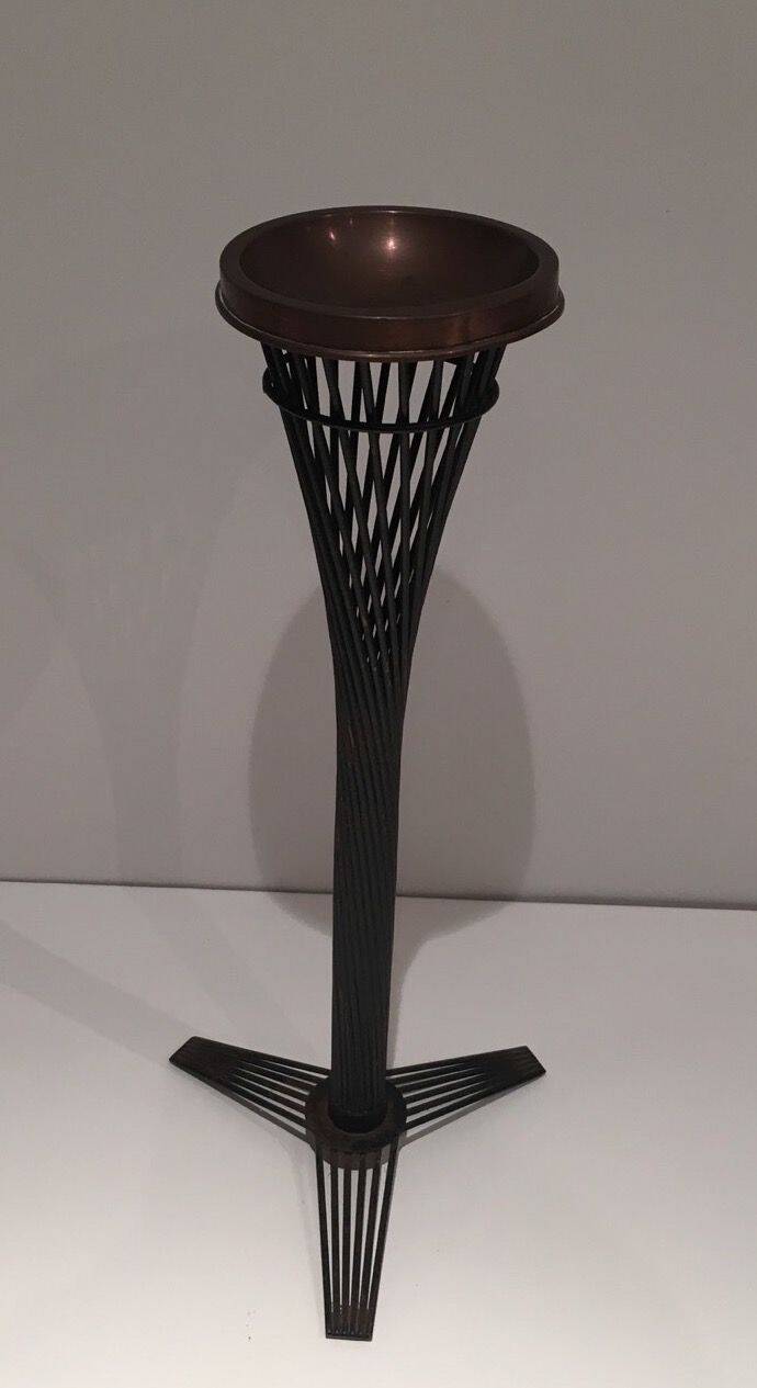 Brass ashtray on a stand made of black lacquered metal wire.