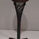 Brass ashtray on a stand made of black lacquered metal wire.