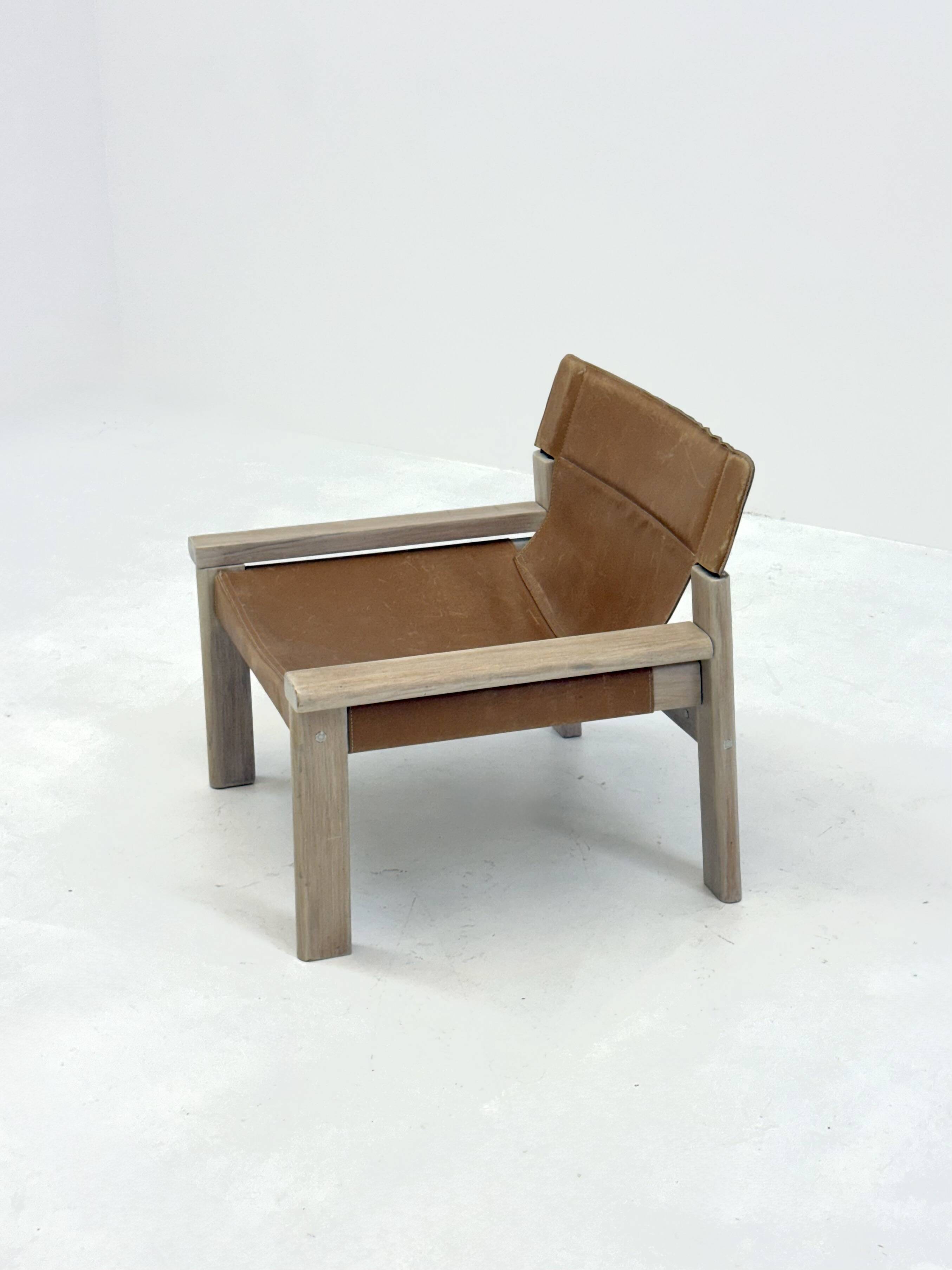 Stylish vintage armchair with saddle leather seat
