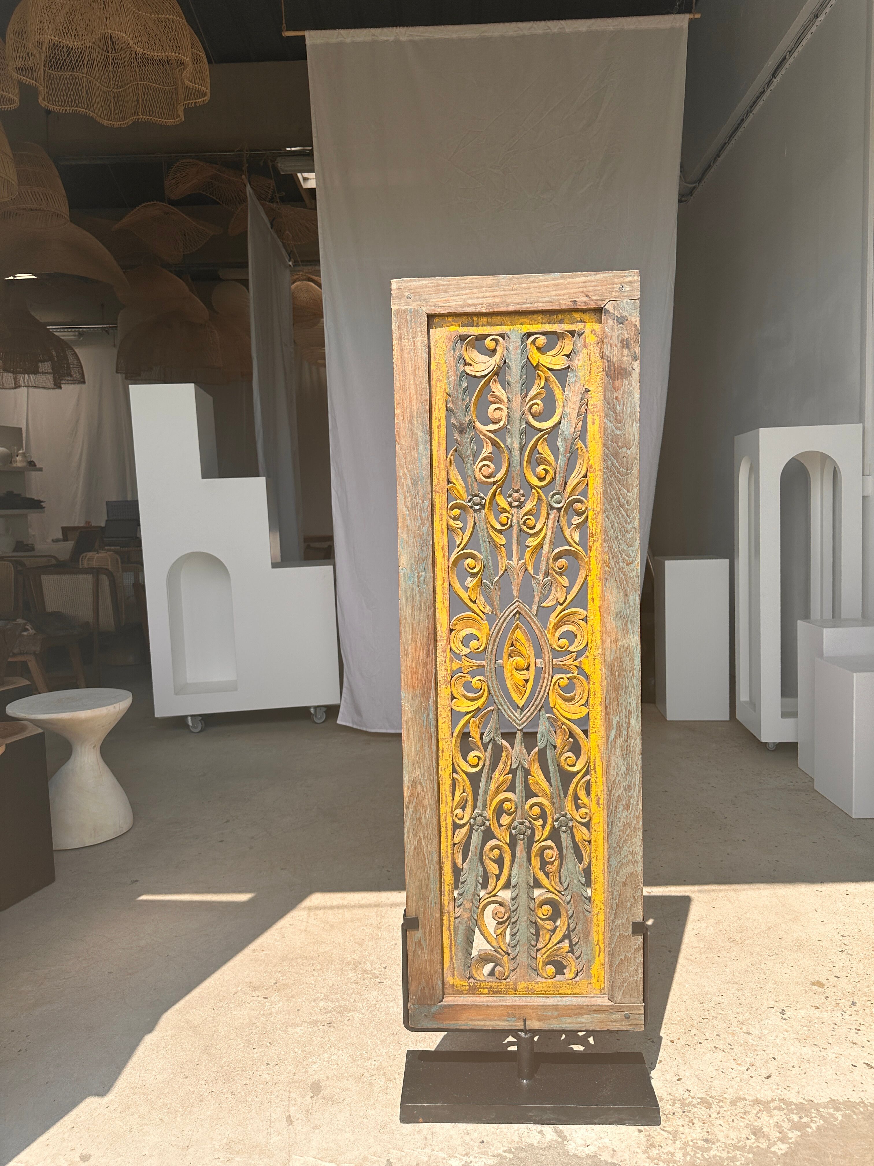 Rectangular Indonesian construction element with blue and yellow plant in carved wood