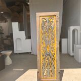 Rectangular Indonesian construction element with blue and yellow plant in carved wood
