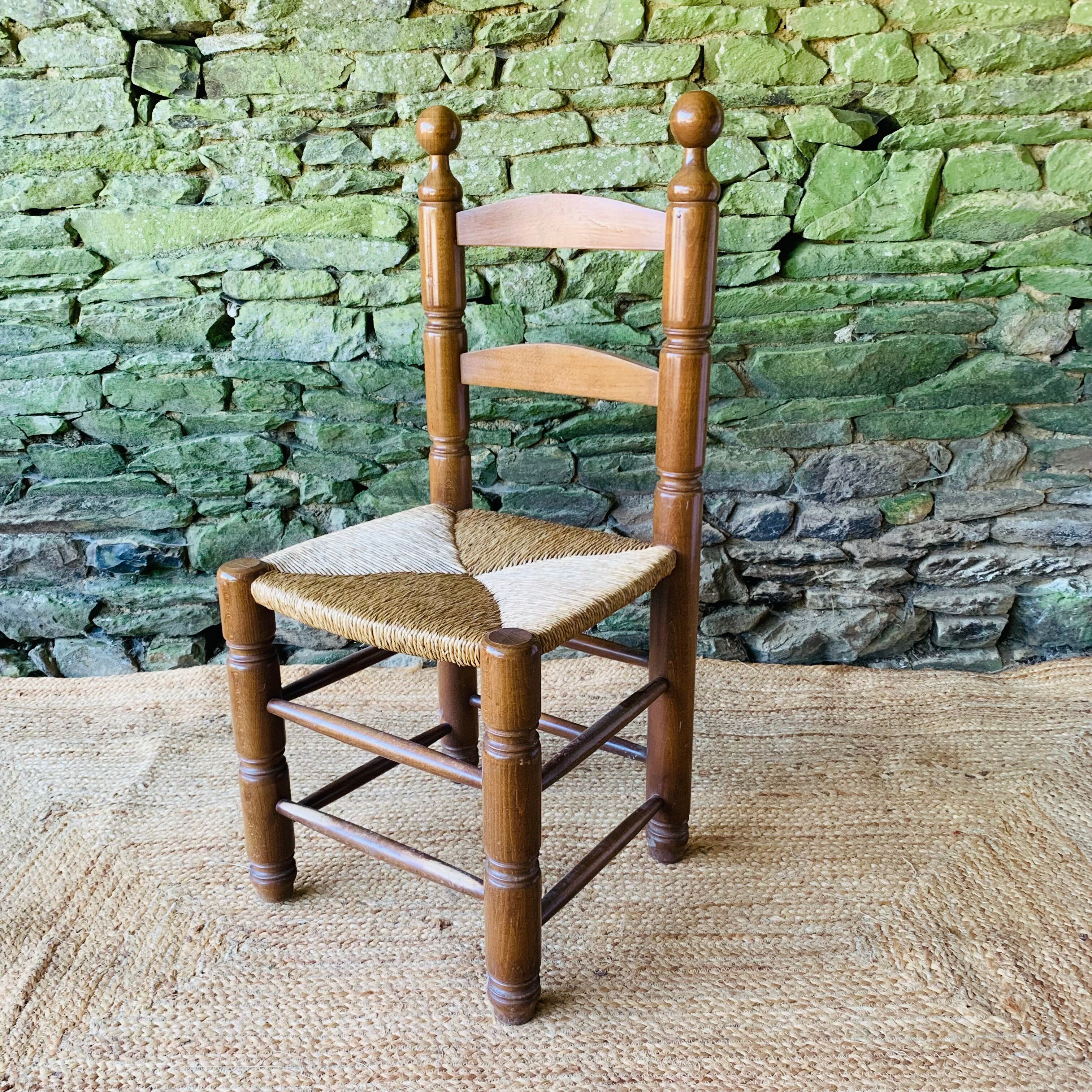 Set of 4 solid wood chairs with straw seats.