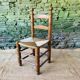Set of 4 solid wood chairs with straw seats.