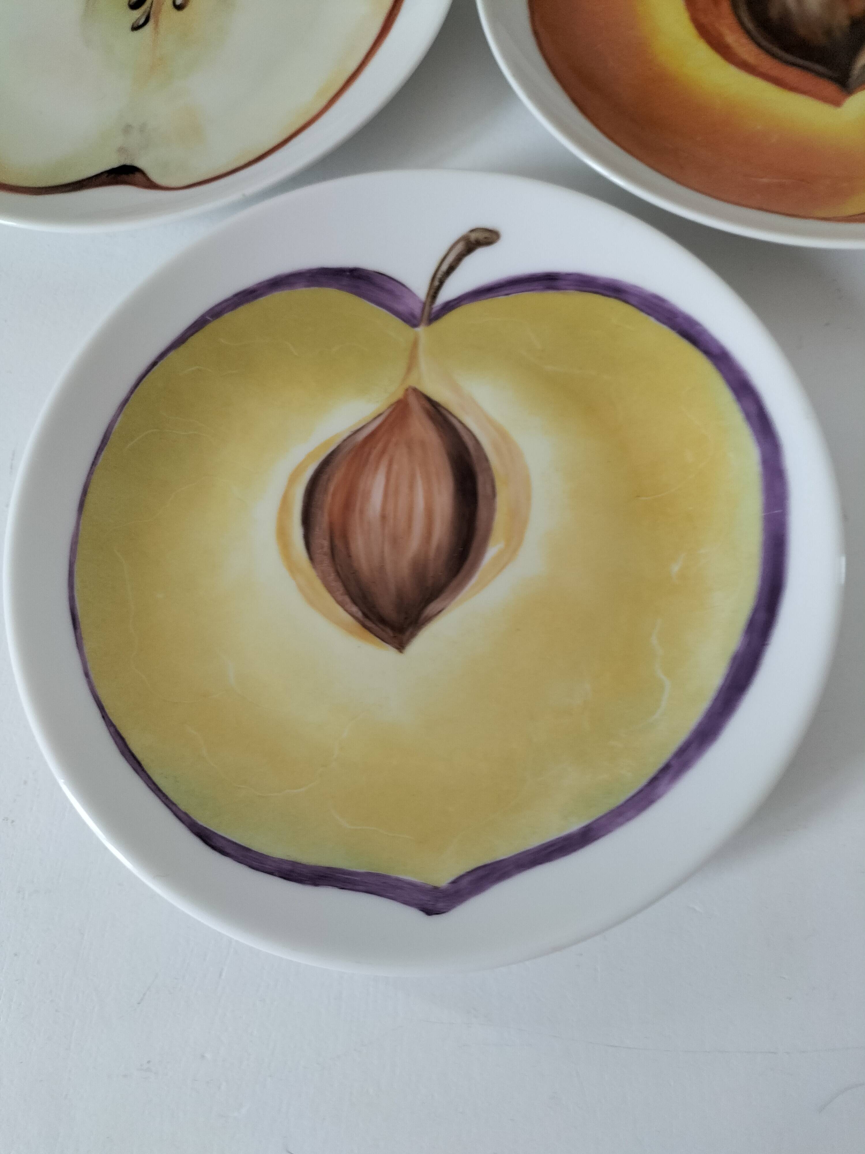 5 hand-painted dessert plates with stylised fruit designs.
