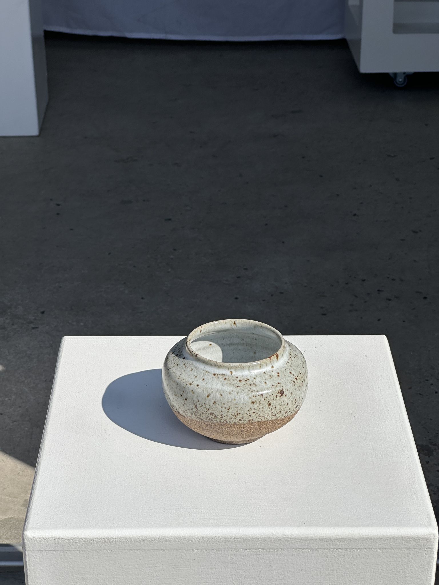 Small white ball vase tight neck in glazed speckled ceramic